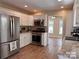 Bright kitchen featuring stainless steel appliances, white cabinetry, and granite countertops at 625 Wildwood Dr, Rock Hill, SC 29730