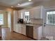 Functional kitchen with stainless steel dishwasher, white cabinets and hardwood floors at 625 Wildwood Dr, Rock Hill, SC 29730