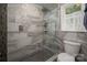 Modern bathroom featuring gray tile shower with glass door and rain shower head at 6512 Porterfield Rd, Charlotte, NC 28226