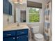 Well-lit bathroom with blue vanity, neutral wall color and shower at 6512 Porterfield Rd, Charlotte, NC 28226