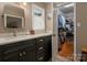 Bathroom featuring gray vanity with marble countertop and open closet at 6512 Porterfield Rd, Charlotte, NC 28226