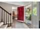 Bright foyer featuring a striking red front door and views into adjacent dining room at 6512 Porterfield Rd, Charlotte, NC 28226