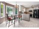 Eat-in kitchen featuring stainless steel appliances, white cabinetry, and ample sunlight at 6512 Porterfield Rd, Charlotte, NC 28226
