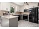 Modern kitchen featuring stainless steel appliances, white cabinets and tile floors at 6512 Porterfield Rd, Charlotte, NC 28226