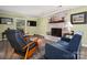 Inviting living room featuring a painted brick fireplace, hardwood floors, and neutral walls at 6512 Porterfield Rd, Charlotte, NC 28226