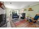 Bright living room showcases fireplace, hardwood floors, and open access to dining area at 6512 Porterfield Rd, Charlotte, NC 28226