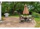 Outdoor patio with table and chairs, grill, and fenced in backyard at 6512 Porterfield Rd, Charlotte, NC 28226