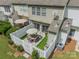 Aerial view of fenced patio with wood furniture set, sun umbrella, and manicured turf at 6917 Rothchild Dr, Charlotte, NC 28270