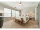 Bright bedroom with three windows, a ceiling fan, and a comfortable king-sized bed at 6917 Rothchild Dr, Charlotte, NC 28270