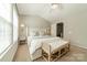 Cozy bedroom featuring a ceiling fan, neutral walls, and a comfortable king-sized bed with bench at 6917 Rothchild Dr, Charlotte, NC 28270