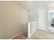 Minimalist hallway with neutral paint and carpet, and a storage closet with a white door at 6917 Rothchild Dr, Charlotte, NC 28270