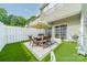 Charming fenced patio with wood furniture set, sun umbrella, and manicured turf at 6917 Rothchild Dr, Charlotte, NC 28270