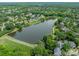 Aerial view of a large pond surrounded by homes and lush greenery, with walking paths along the shore at 6917 Rothchild Dr, Charlotte, NC 28270