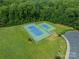 Aerial view of well-maintained community tennis courts surrounded by green landscaping and parking at 6917 Rothchild Dr, Charlotte, NC 28270
