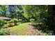 Secluded backyard with mature trees and plenty of green space at 7021 Linda Lake Dr, Charlotte, NC 28215