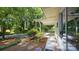 Charming home exterior with a covered patio, landscaped yard, and view of surrounding trees at 7021 Linda Lake Dr, Charlotte, NC 28215