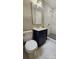 Modern bathroom featuring marble floors, a navy vanity, and a glass shower at 7021 Linda Lake Dr, Charlotte, NC 28215