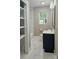 Bright bathroom with dark vanity, marble floors, and modern lighting, creating a stylish retreat at 7021 Linda Lake Dr, Charlotte, NC 28215