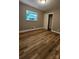 This bedroom features hardwood floors, neutral paint, one window, and a closet at 7021 Linda Lake Dr, Charlotte, NC 28215
