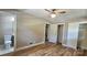 Neutral bedroom featuring a ceiling fan, closet, and adjacent bathroom, offering comfort and convenience at 7021 Linda Lake Dr, Charlotte, NC 28215