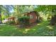 Well-maintained brick home with manicured landscaping and mature trees at 7021 Linda Lake Dr, Charlotte, NC 28215