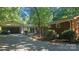 Exterior view of a brick home with a carport and well-maintained landscaping at 7021 Linda Lake Dr, Charlotte, NC 28215