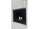 White brick fireplace with black interior and decorative candles adding warmth to the living space at 7021 Linda Lake Dr, Charlotte, NC 28215