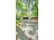 Ranch-style home with a covered carport and a gravel driveway surrounded by mature trees at 7021 Linda Lake Dr, Charlotte, NC 28215