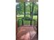 View from the covered front porch of a home with brick flooring and iron railings at 7021 Linda Lake Dr, Charlotte, NC 28215