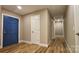 Hallway with blue and white doors and wood-look flooring, creating a welcoming entrance at 7021 Linda Lake Dr, Charlotte, NC 28215