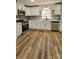 Modern kitchen featuring new stainless steel appliances, white cabinets, and stone countertops at 7021 Linda Lake Dr, Charlotte, NC 28215