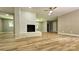 Large living room featuring a white brick fireplace and wood look flooring at 7021 Linda Lake Dr, Charlotte, NC 28215