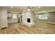 Spacious living room featuring a painted brick fireplace, hardwood floors, and ample natural light at 7021 Linda Lake Dr, Charlotte, NC 28215