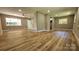 Open living room with hardwood floors, light paint, and brick column at 7021 Linda Lake Dr, Charlotte, NC 28215