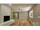 Bright living area featuring a brick fireplace, wood-look floors, and abundant natural light at 7021 Linda Lake Dr, Charlotte, NC 28215