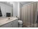 Neutral bathroom features a single sink vanity with a shower and tub combination with a shower curtain at 706 Evans Manor Dr, Weddington, NC 28104