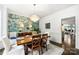 Elegant dining room featuring a floral accent wall, chandelier, and dark wood table with seating for six at 706 Evans Manor Dr, Weddington, NC 28104