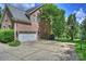 Exterior of a brick home showing a driveway, garage and basketball court at 706 Evans Manor Dr, Weddington, NC 28104