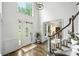 Bright foyer with hardwood floors, staircase, and a large window above the front door at 706 Evans Manor Dr, Weddington, NC 28104