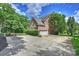 Spacious driveway leads to a 2 car garage. Mature landscaping and a basketball hoop are visible at 706 Evans Manor Dr, Weddington, NC 28104