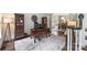 Spacious home office showcasing a wooden desk with dual monitors and decorative display cases at 706 Evans Manor Dr, Weddington, NC 28104