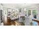 Open concept featuring white kitchen, stainless steel appliances, granite counters, and an adjacent breakfast nook at 706 Evans Manor Dr, Weddington, NC 28104