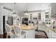 Bright kitchen with stainless steel appliances, granite countertops, and stylish barstool seating at the island at 706 Evans Manor Dr, Weddington, NC 28104