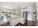 Open concept featuring white kitchen, stainless steel appliances, granite counters, and an adjacent breakfast nook at 706 Evans Manor Dr, Weddington, NC 28104