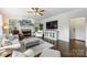 Inviting living room with a cozy fireplace, plantation shutters, and comfortable seating arrangements at 706 Evans Manor Dr, Weddington, NC 28104