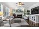 Inviting living room with a cozy fireplace, plantation shutters, and comfortable seating arrangements at 706 Evans Manor Dr, Weddington, NC 28104