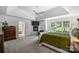 Large primary bedroom with a fireplace, view of a bath, and green accents at 706 Evans Manor Dr, Weddington, NC 28104