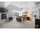 Spacious primary bedroom with tray ceilings, fireplace, and plush carpet at 706 Evans Manor Dr, Weddington, NC 28104