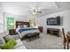 Comfortable primary bedroom featuring a ceiling fan and mounted TV at 706 Evans Manor Dr, Weddington, NC 28104