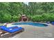Scenic pool with lush greenery, a charming cabana, and cozy seating for outdoor relaxation at 706 Evans Manor Dr, Weddington, NC 28104